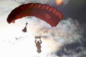 People, flying on the parachutes, in the clouds, in the colorful lights