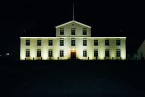 Landscape with the white house with lights, among the darkness, at the night
