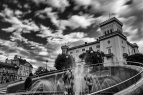 fountain on square in city, black and white