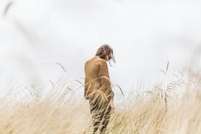 Girl Alone on reed field