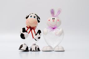 toy cow and rabbit on a white background