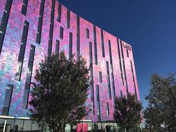 Colorful, shiny building and plants in London, England, under the blue sky