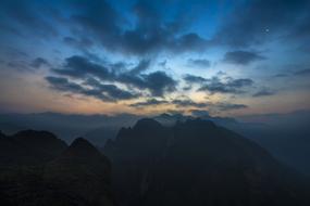 a black rock in the clouds