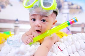 photo of a baby with a snorkel and mask