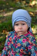 baby in a colorful jacket on a blurred background