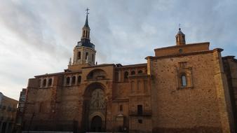 Beautiful, old architecture with the tower, under the sky with clouds