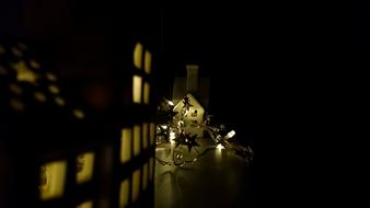 Close-up of the Christmas decorations and lights, among the darkness