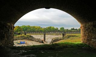 Beautiful and colorful landscape with the bridge among the plants, from the arch