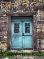 Blue, wooden door in the old, colorful building