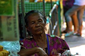 old woman selling goods at the market