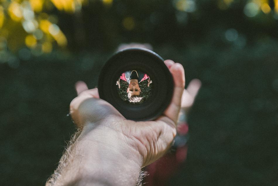 lens in hand on blurred background