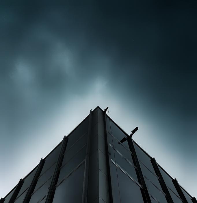 Corner of the building, under the dark sky, clipart