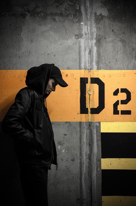 guy in the hood near the concrete wall