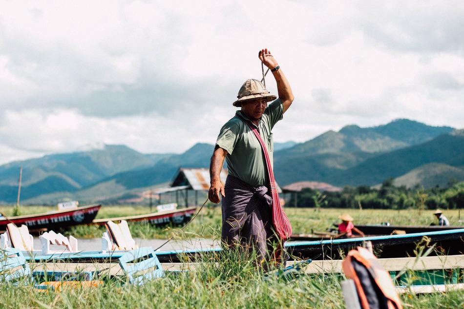 Man among the green field among the beautiful green mountains