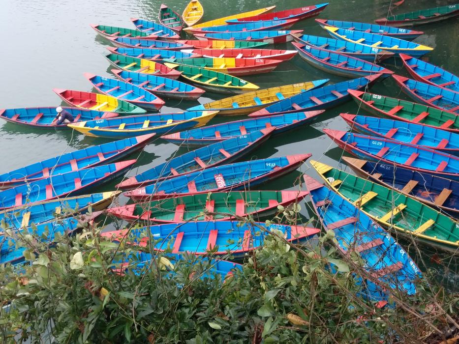 colored beautiful boats at the pier in the lake