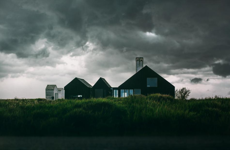 houses in the village against the background of evening clouds