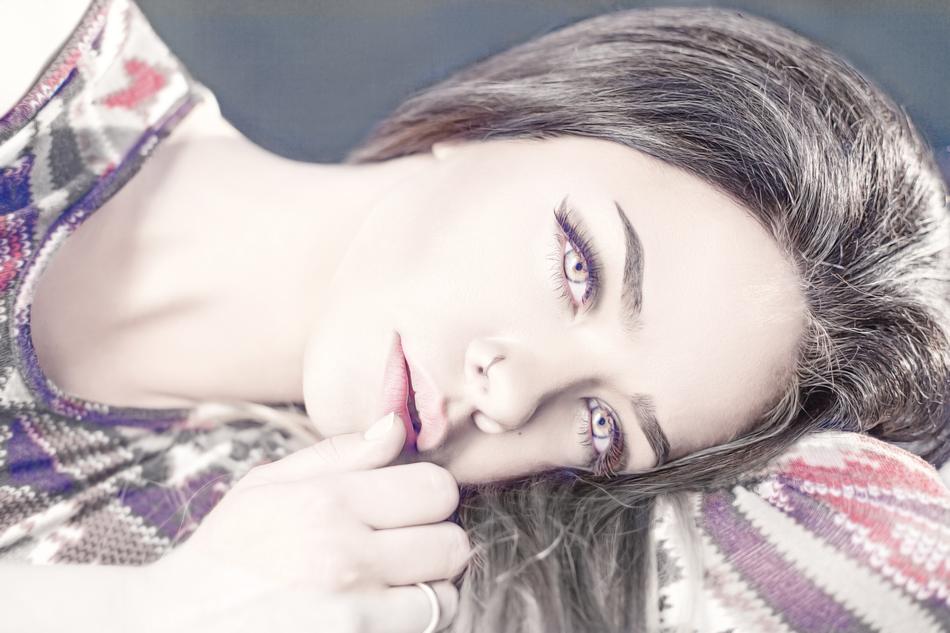 Portrait of the beautiful, laying woman, in light