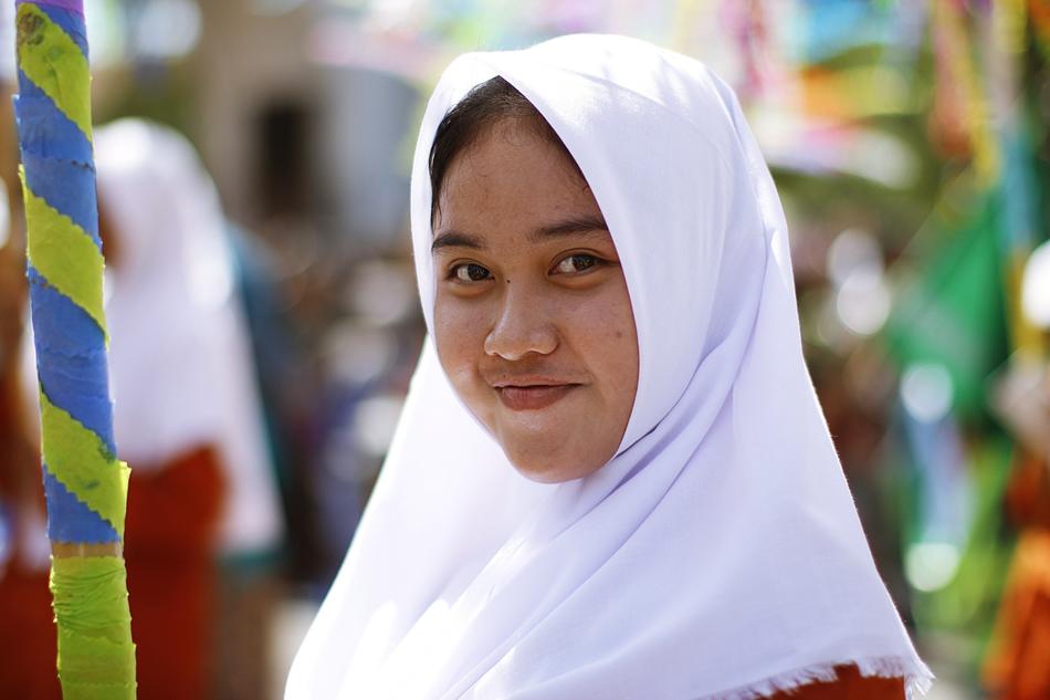 girl in a white kerchief at the fair