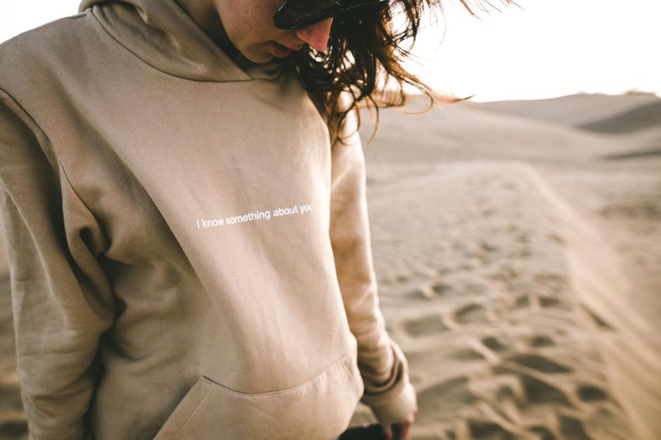 woman in hoodie in the desert close up