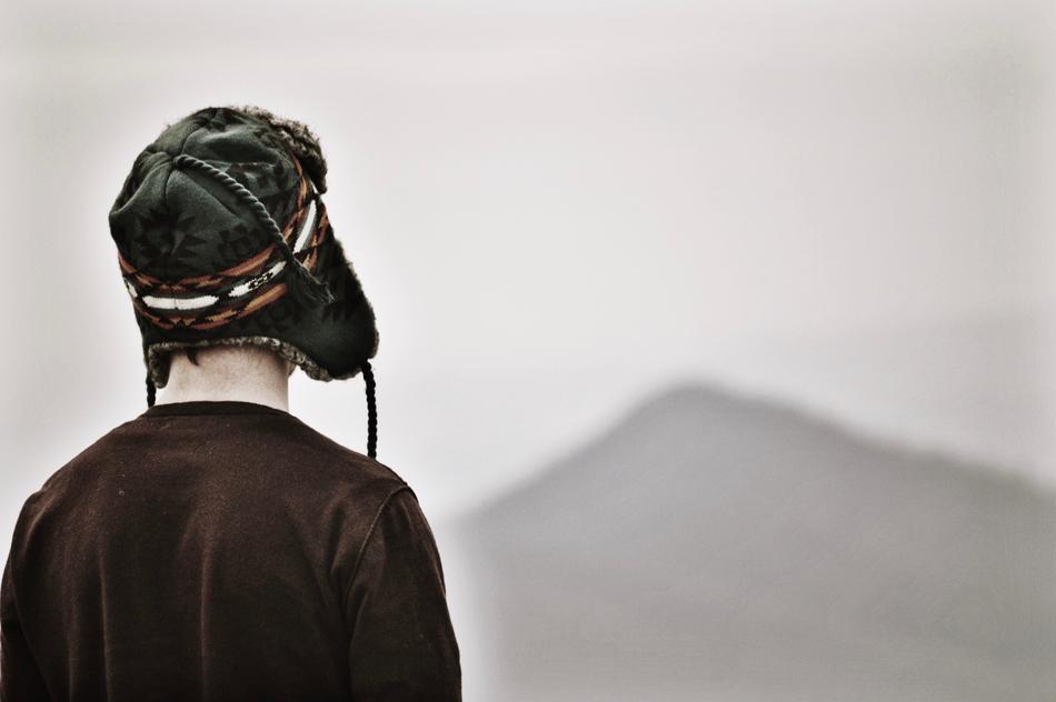 Back view of the man in hat near the beautiful mountain