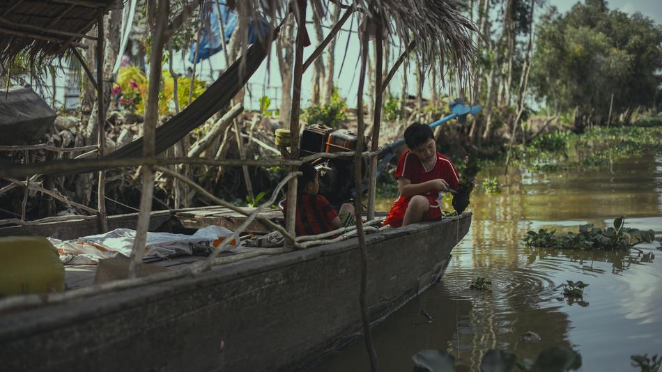children in a hut near the river