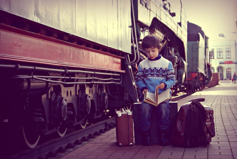 Baby with luggage near Train