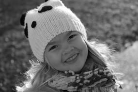 monochrome photo of a girl in a white black hat