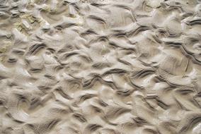 Close-up of the beach sand with pattern and shapes