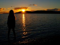 girl silhouette at Sunset by Water