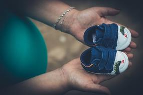 Pregnant woman with Child Shoes