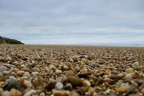 stone beach by the sea with clouds