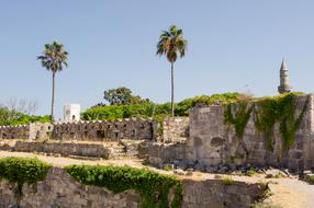 Beautiful landscape of the old castle with green plants in Greece, under the blue sky