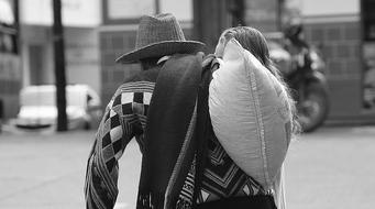 black and white photo of a man with a bag