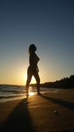 sexy Girl Posing on Beach at sunset