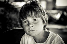 black and white, carefully looking boy