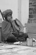 homeless man in turban in black and white background