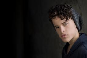 guy with curly hair on a black background