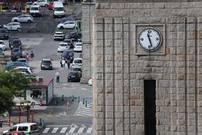 Clock tower, with background with people and cars, in Spain