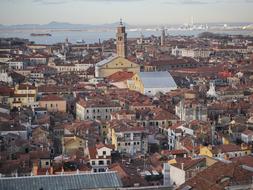 Panorama of the city with colorful buildings, near the water, at background with mountains
