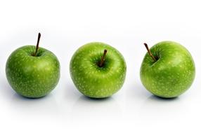 Three ripe apples on a white background