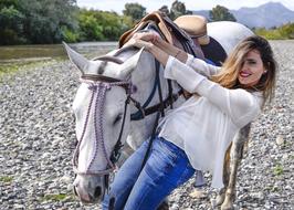 the girl with the white horse on the beach.