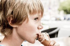 boy is eating chocolate ice cream