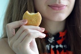 Girl holding a cookie in her hand