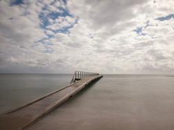 long bridge by the sea in the clouds