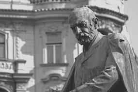Black and white photo of the beautiful, copper statue of the man in Prague, Czech Republic