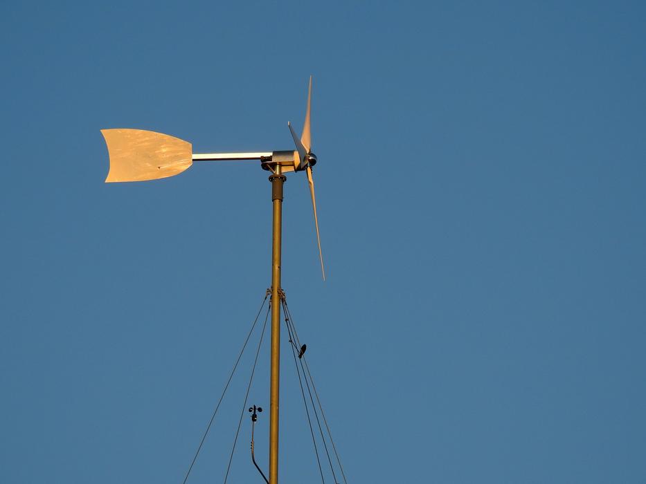 Close-up of the yellow windmill, at blue sky on background