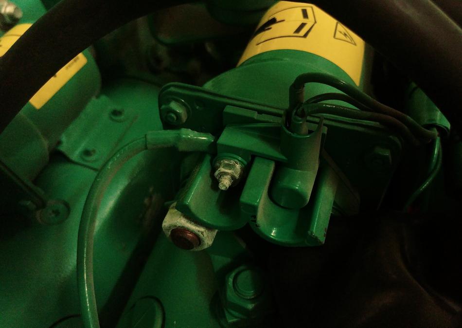 Close-up of the green, black and yellow machine engine with signs