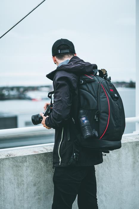 photographer with backpack on the waterfront in Liverpool