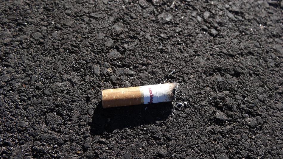 Cigarette Butt on Pavement Road