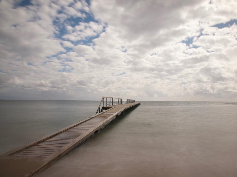long bridge by the sea in the clouds